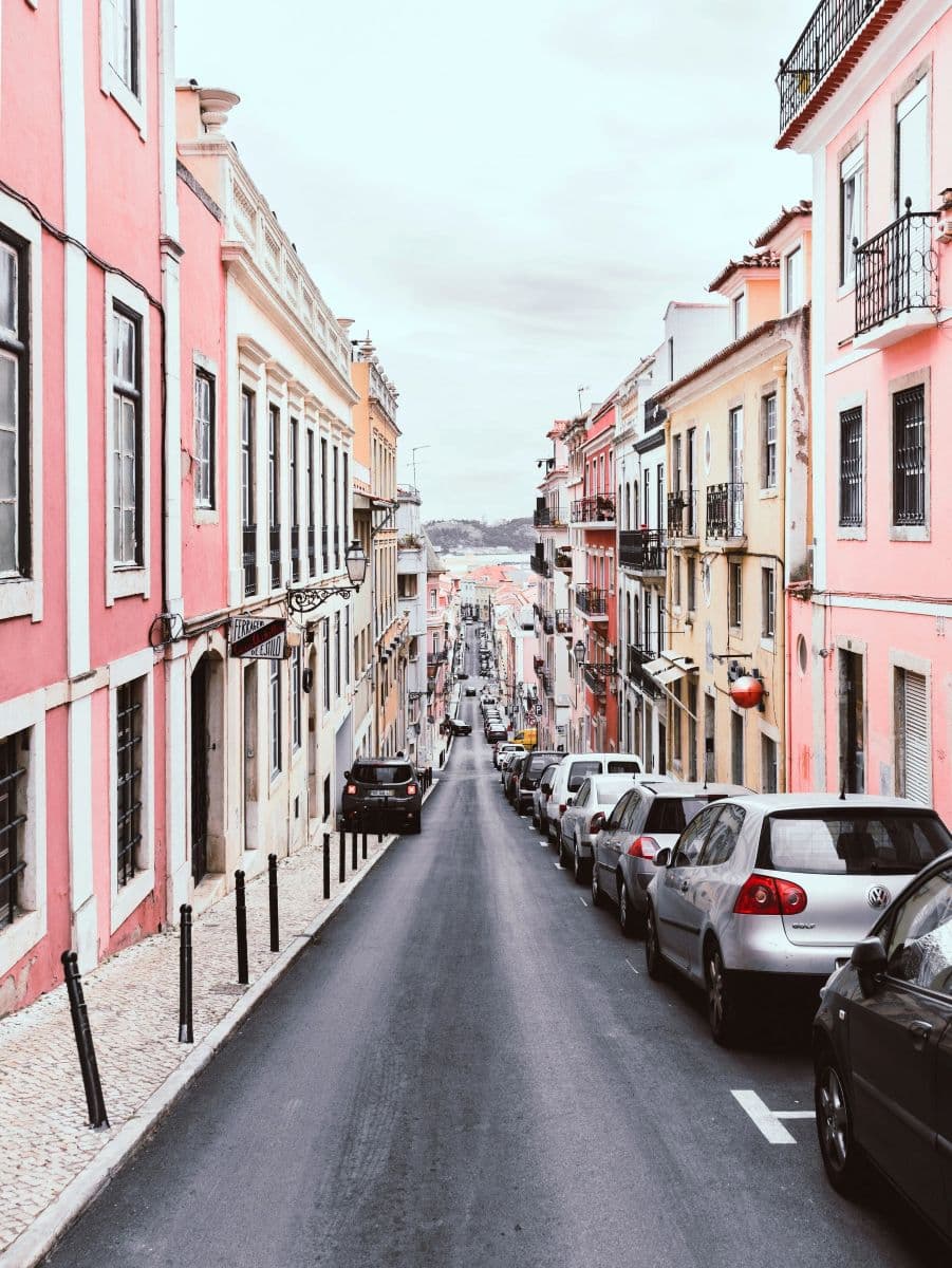 Narrow hillside street with cars parked on both sides